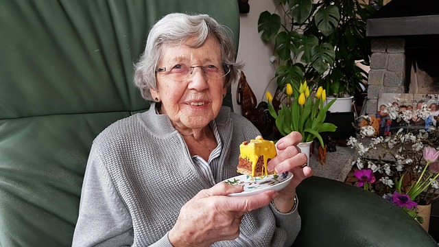 older lady holding a cake