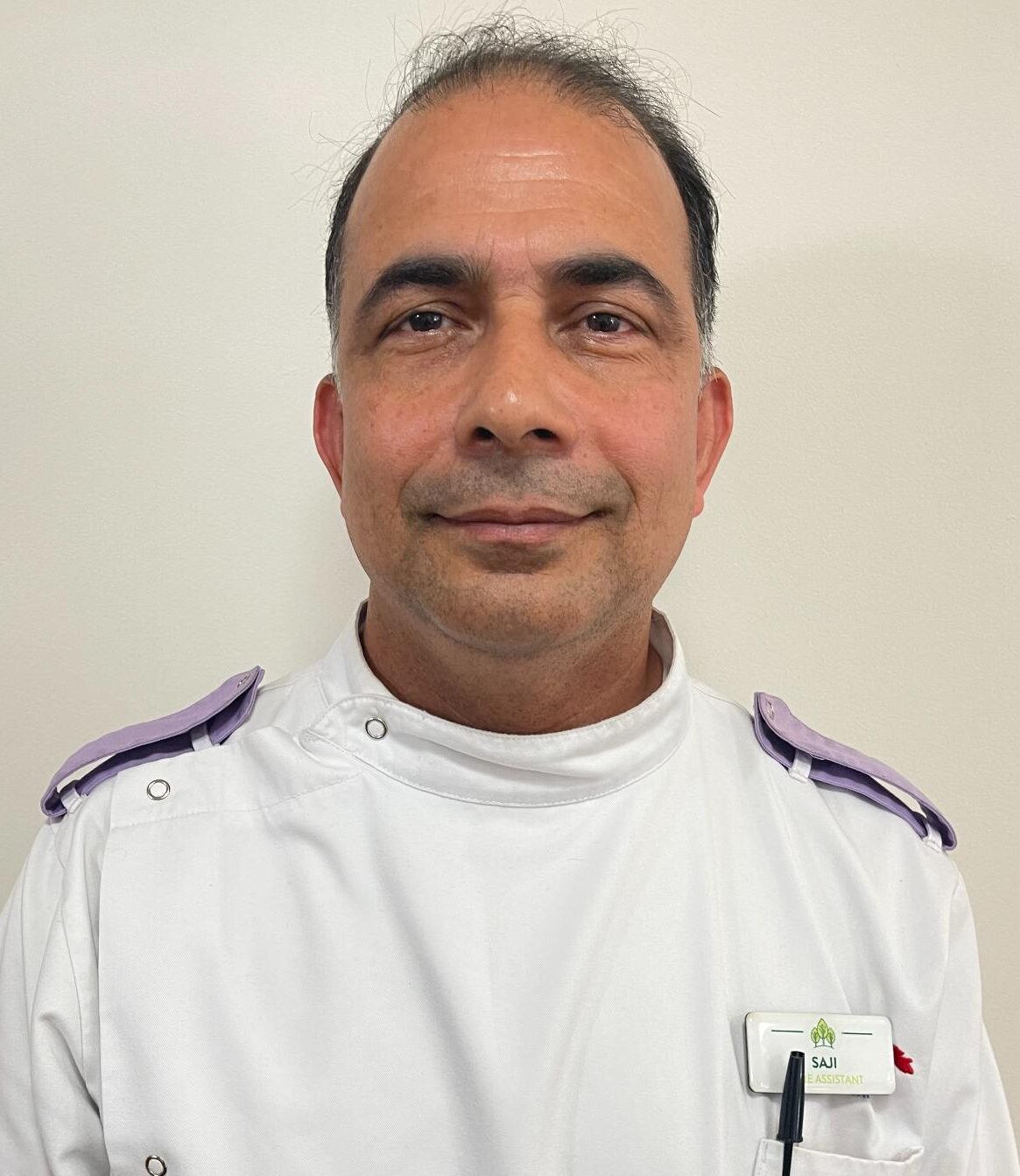 man in white nurses uniform smiling